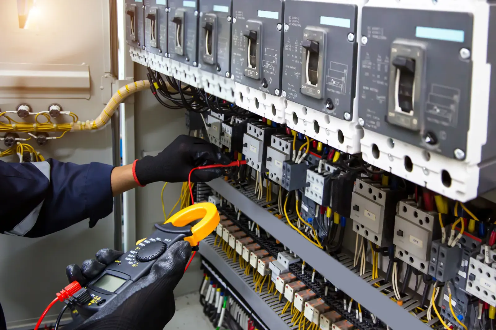 BSEC electrician testing a commercial breaker panel in Greater Phoenix, AZ
